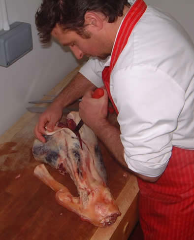 Paul boning leg of beef at Savin Hill Farm